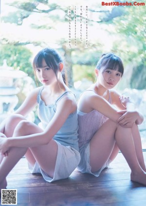 Two young women in school uniforms standing next to each other.