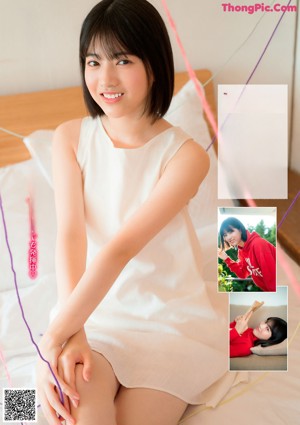 A young woman laying on top of a wooden table.