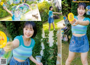 A woman in a blue top and denim skirt posing for a picture.