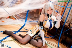 A woman with long white hair is posing for a picture.