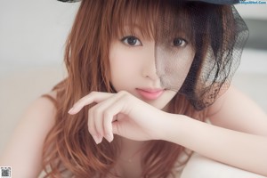 A woman in a black lingerie leaning against a wall.