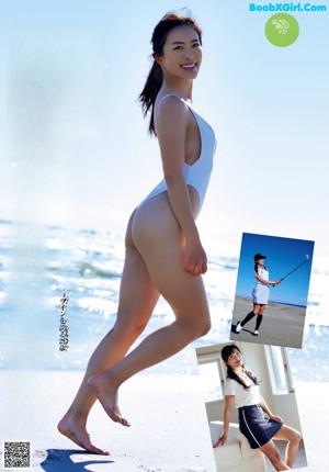 A woman in a white bathing suit walking on the beach.
