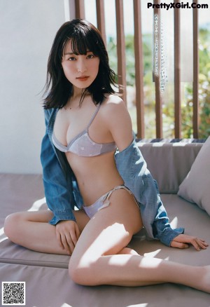 A woman in a floral dress is featured in a magazine.