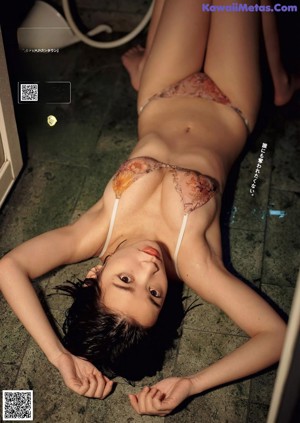 A woman sitting in a bathtub with her legs crossed.